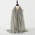 Close-up of grey crinkled cotton linen scarf showing frayed edges and soft texture - Medium Grey