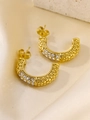 Detailed macro view of gold C-shaped earrings with grain texture and sparkling zircon stones - Gold C-shaped Granular Texture