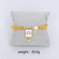 Gold beaded stretch bracelet with faith charm, pearl and heart pendant, weight 20g - White Fé Faith Charm Bracelet (Gold)