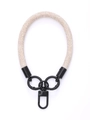 Detailed view of beige braided wrist strap with black metal clips for mobile phone cases - Sand Ginger