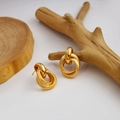 Triple interlocking hoop earrings with polished and frosted gold finish on a wood branch - Frosted & Polished Triple Rings
