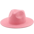 Detailed macro view of the spiral woven texture on a pink straw fedora sun hat - Pink