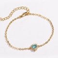 Macro detail of gold-plated chain with light blue heart gemstone and white zircon setting - Heart Sea Blue Zirconia