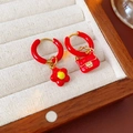 Macro detail of asymmetric red flower and handbag enamel charms on gold hoop earrings - Asymmetric Flower & Handbag Style / Ear Buckle-Red-Flower