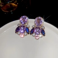 Macro shot of vintage gold earrings with colorful crystals and sparkling starburst effects - 76# Silver Needle - Purple