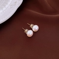 Detailed shot of pearl earrings with gold posts on dark silk background with relief plate - Gold Needle White Pearl Studs (10mm)