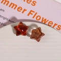 Macro view of star-shaped resin accessories with amber marble texture and glossy finish - Brown