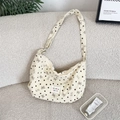 Detail of corduroy crossbody bag with heart and bow patterns on white sofa - Off-white