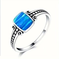 Detailed close-up of retro silver ring featuring rectangular blue opal and engraved scrolls - US 6 / Blue
