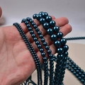Deep blue faux South Sea pearls in various diameters shown on hand for size comparison - 4mm Straight Hole/Approx 100pcs Per Strand / Dark Blue
