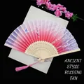 Detail of pink gradient silk folding fan with cherry blossom pattern and bamboo carving - Pink Fluttering