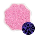 Pink luminous seed beads for DIY jewelry displayed in a white bowl with glowing effect - Magenta