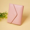 Detail of pink faux leather envelope wallet showing fine stitching and grain texture - Pink