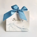 Detail of white marble gift bag with blue ribbon bow and golden Specially text - Blue Bag Blue Ribbon / 11.5*4.5*10