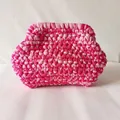 Detailed macro view of the two-tone pink handmade woven cotton fabric clutch bag texture - Rose Pink