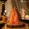 Orange ghost figurine scented candle for Halloween decor on a rustic wood base - Mystery Man (Orange)