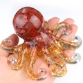 Handheld crystal octopus figurine with red stone filler and gold foil tentacles - Red Agate