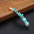 Macro detail of natural turquoise stones embedded in a golden metal hair clip - Turquoise Gold