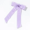 Detail of lavender satin bow hair clip featuring pleated edges and long ribbons - Purple