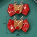 Detail of red Christmas reindeer bow hair clips with glitter accents on green background - Christmas Deer Bow Hair Clip