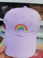 Detail of lavender cotton baseball cap featuring vibrant rainbow embroidery and eyelets - Purple