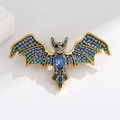 Vintage bat brooch in golden finish with light blue rhinestones and pear-cut stone - Blue