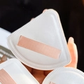 Three triangular white makeup puffs with pink ribbon straps held in hand for detail - Marshmallow Puff [Triangle Bagged]