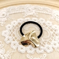 Minimalist black elastic hair tie featuring an irregular gold metal heart charm on lace - Gold Hammered Heart