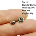 Macro view of 6.5mm antique silver spacer beads with circular relief on a fingertip - 11# (Dia 6.5mm Thick 3mm)
