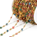 Golden chain with colorful glitter heart charms on a white spool for DIY jewelry - Multi-color