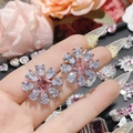 Macro view of pink gemstone flower earrings with square cut main stone and zircons - 0069 Pink Diamond Radial Flower Cluster Studs