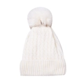 Close-up of white knit beanie featuring thick cable patterns and large faux fur pom-pom - White