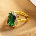 Macro shot of an emerald-cut green gemstone ring with pavé diamonds on a silk background - Gold (Green Stone)