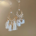 Bohemian rhombus gold earrings with white tassels and beaded details on a display stand - Vintage Leaf Cotton Tassel Style