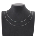 Double-layered silver titanium steel necklace with small green beads on a black mannequin - Silver Dark Green Beads (KN201895-Z)