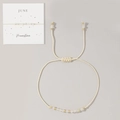 Adjustable woven June Moonstone bracelet with golden beads on a white display card - June-Moonstone (Card Pack)