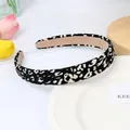 Padded leopard print headband in black and white animal pattern with soft suede lining - Black Leopard