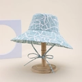 Light blue double-sided bucket hat with white abstract patterns and an elegant chin bow - S-Shaped Line Style / Blue