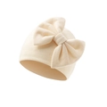Close-up of cream-white ribbed knit baby beanie with large decorative bow detail - Apricot (Bow Turban Hat)