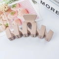Matte beige wavy hair claw clip with minimalist geometric hollow design for women - Nude Pink