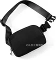 Minimalist black nylon waist bag with adjustable strap and silver metal zipper closure - Black