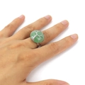 Detailed view of handmade tree of life ring with green gemstone on model hand - Green Aventurine
