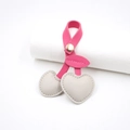 Close-up of pink and cream leather cherry bag charm with golden snap and heart details - Gray