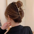 Elegant gold wavy metal hair claw clip shown on a model for a sophisticated hair look - Streamlined Twisted Wave Style / Large / Gold