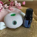 Close-up of a white sphere essential oil diffuser with dōTERRA peppermint oil set - Elegant White Sensor Machine + Peppermint Essential Oil Set