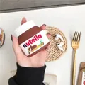 Brown Nutella-inspired silicone case for AirPods with hook hole in a lifestyle setting - Chocolate Sauce + Carabiner / AirPods 1/2 Gen