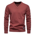 Close-up of V-neck neckline and ribbed cuffs on brick red men's cotton knit sweater - Brick Red