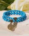 Detailed view of beaded bracelets with tree of life and leaf pendants on white stone - Blue Turquoise