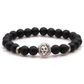 Close-up of matte black lava stone beads with a vintage silver lion head charm - Matte Black Stone With Silver Lion