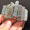 Macro shot of handmade labradorite hair comb with moon and star metal charms - Labradorite